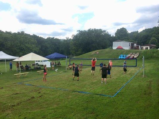 Volleyball on the riverbank and canoe and kayak rentals located next door at the boat launch.