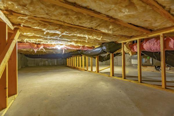 A successfully completed crawl space insulation installation using high quality fiberglass insulation.