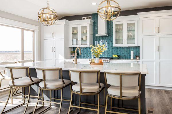 white cabinets with calcatta countertops and blue backsplash