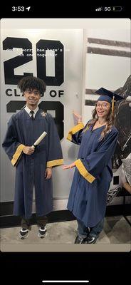 My boyfriend and I posing in front of the "class of 2023" sign