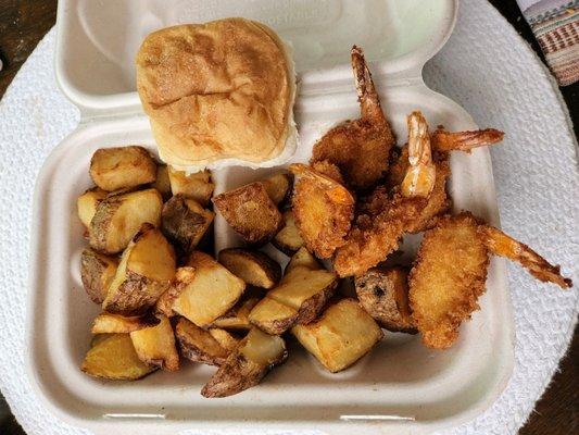 Shrimp snack with shack potatoes and a roll