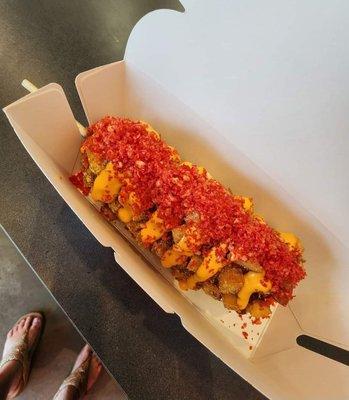 Half cheese half beef potato dog in hot Cheetos with special sauce