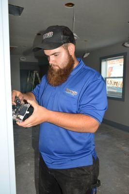 Technician installing light switch