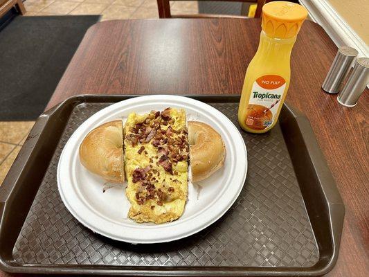 Meat Lovers omelet with toasted plain bagel buttered, orange juice.