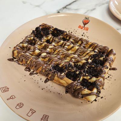 Chocolate and oreo crumbs on a waffle