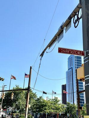 The Iconic "Charm'tastic Mile" Street Sign with Harborplace in the background.