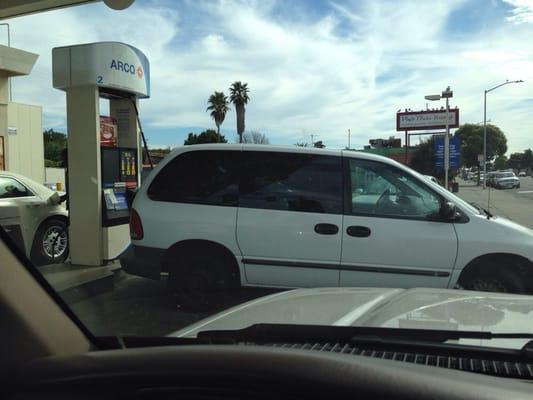 Woman behaving badly as a discourteous customer:  I wanted to leave Arco but, she blocked the entire driveway parked sideways!