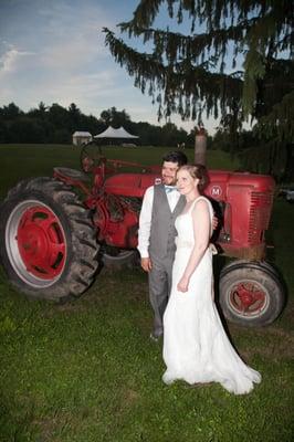 By the iconic red tractor with the tent up on the hill