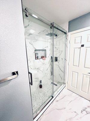 Walk in shower with custom frameless sliding glass doors