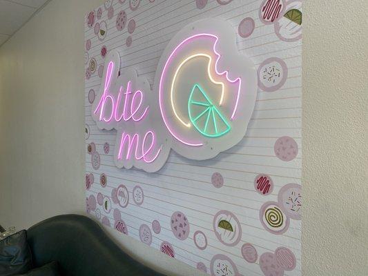 faux neon sign on acrylic backer mounted over printed vinyl and wall standoffs