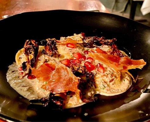 Ravioli in mushroom cream sauce with pomegranate seeds