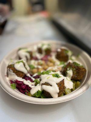 Aladdin's Middle Eastern Salad Bowl with Our Homemade Falafel, Tahini, and fresh veggies prepped daily!