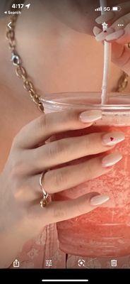 Pink-white nails with super small red heart detail on middle finger. TWO WEEKS AND THEY STILL LOOKED THAT GOOD!