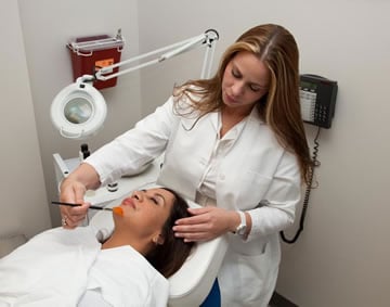 State of the Art Medi Spa an aesthetician is performing Dermatude a nonsurgical facelift alternative.