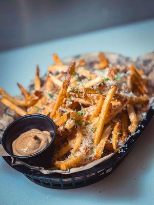 truffle fries- basket of hand-cut fries, black truffle salt, freshly shaved parmesan, & parsley with a side of black garlic peppercorn aioli