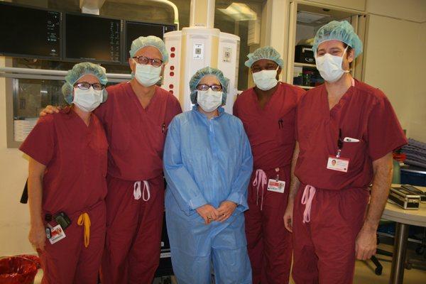 Dr. Stieg in the operating room with Martha Pollack, 14th President of Cornell University.