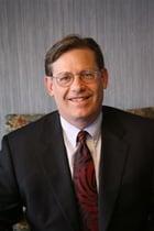 BRUCE M. BROWN, Shareholder