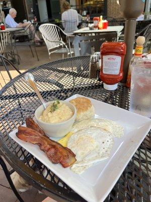 The full breakfast of eggs, bacon, cheese grits and a biscuit.