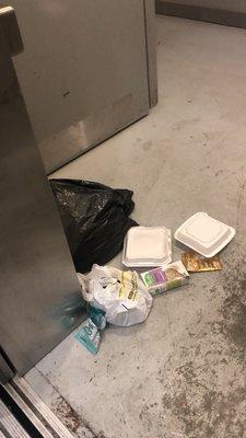 Trash splattered everywhere by the elevator