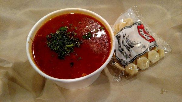 Cup of fish stew with oyster crackers