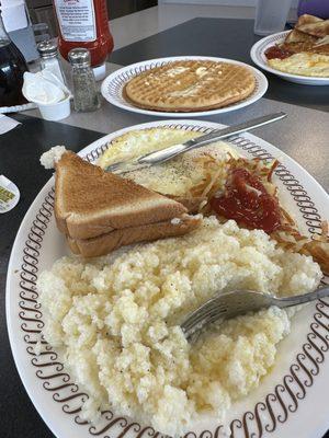 Grits toast eggs hash browns and waffle