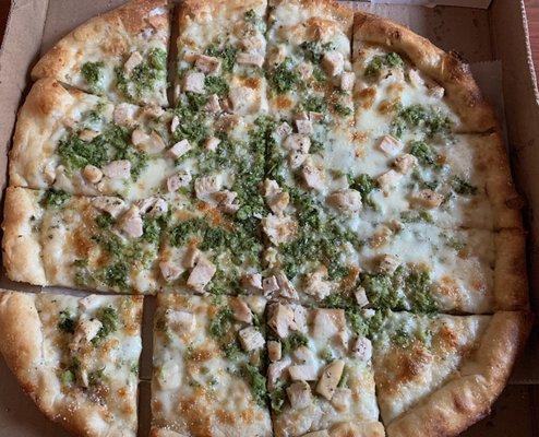 Chicken broccoli pizza with white garlic sauce.