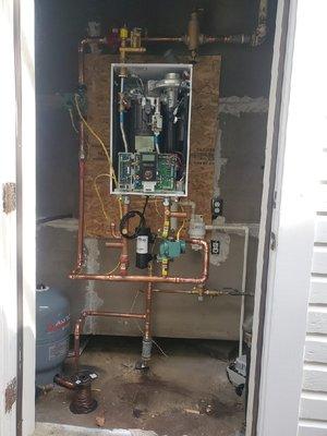 After - New high efficiency Navien tankless propane boiler & new piping & valves