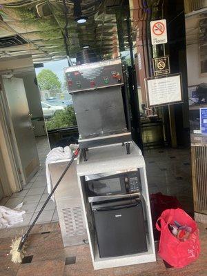 The coffee machine that Never had coffee in it right in front of the "Breakfast room" that never had any food of any kind.