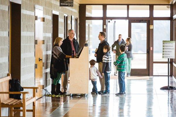 A family checks their children into our Learning Center