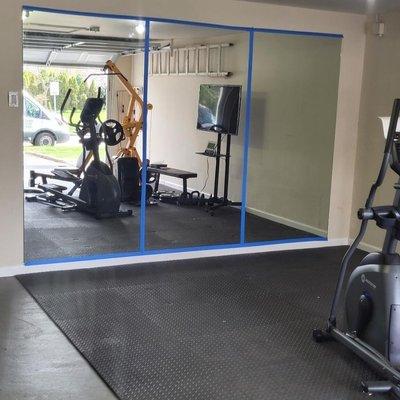 Garage converted into a home gym. Simple transformation with these custom mirrors!