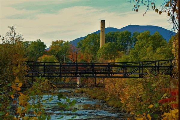 Claremont walking bridge in the foreground and Sullivan smokestack in the background