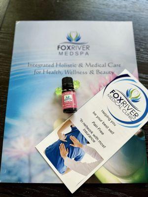 The folder and brochure from Fox River medical clinic, even one of their essential oils!