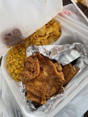 Plate with fried pork chop, fried chicken, mac n cheese, corn, and cornbread