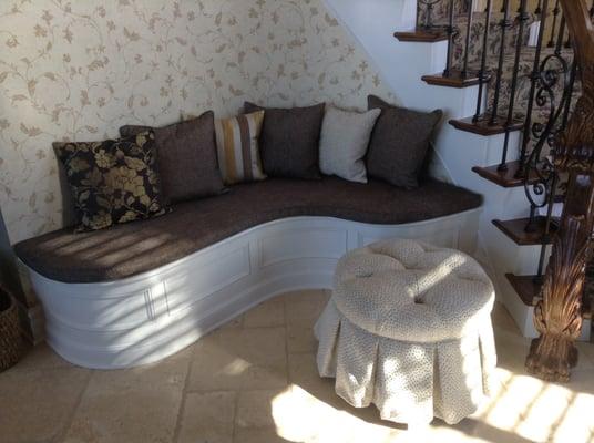 A new custom bench seat with 6 designer pillows and a tufted top ottoman from Bassett.