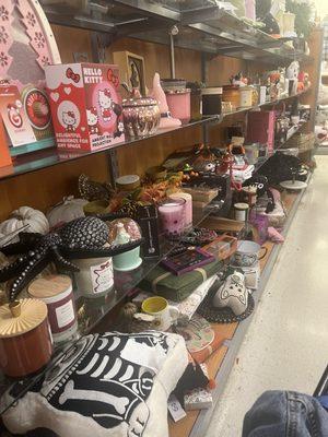 A whole row of Halloween items, Clearance, candelabra is on shelf with other items red sticker with a Marshall's sticker on it.