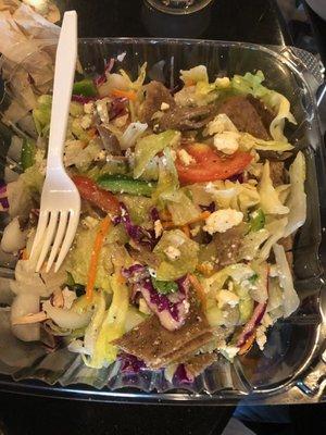 About half of the large salad with gyro meat and feta