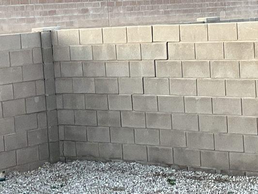 Backyard wall cracked on the bottom and separating on it's way to collapse