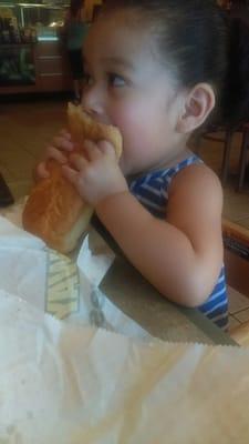 Enjoying her sweet onion chicken teriyaki 6 inch sub with provolone, oil, vinegar, salt and pepper all on italian bread