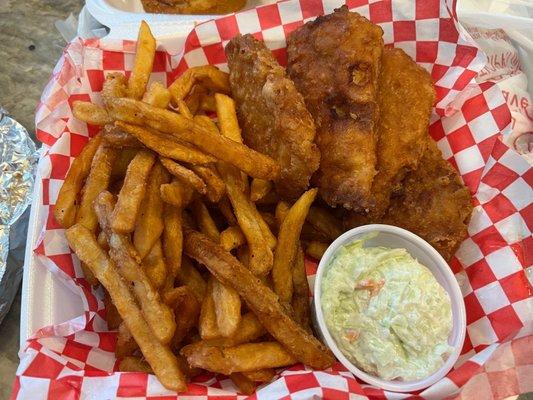 Fish dinner of fried cod, coleslaw, and a mountain of cris fries