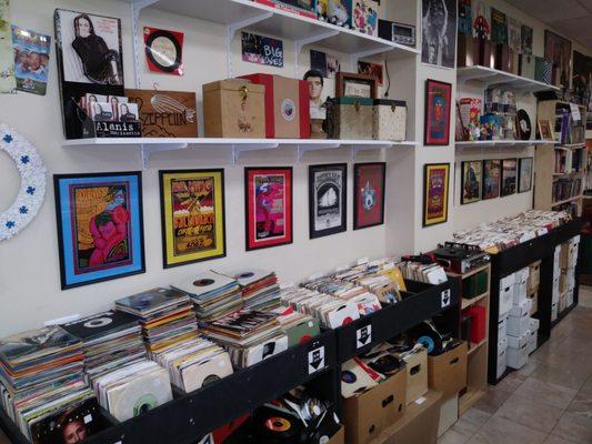 An entire isle of 45s with .50 cent singles below the rack and boxes of picture sleeves and singles separated by genre on the bottom right.