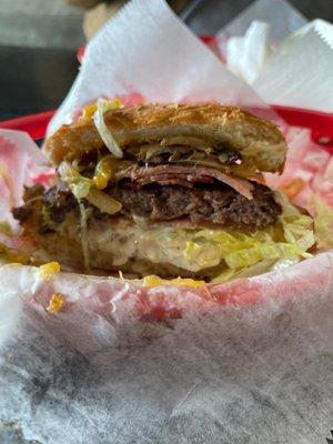 Jim Burger with cheese,ham, bacon, mushrooms onions lettuce, tomato & jalapeño on a fresh made bun.