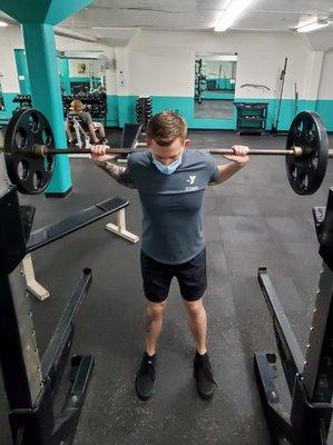 Man doing squats with barbell