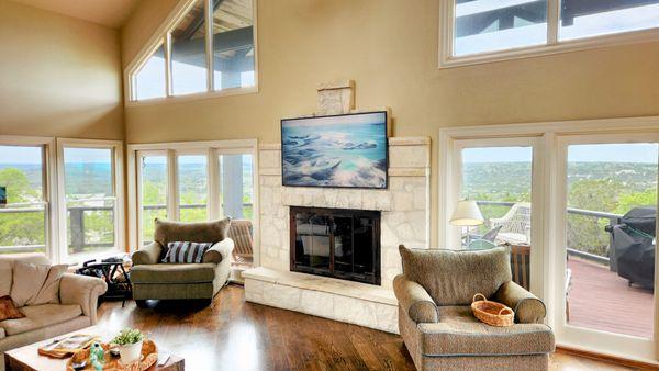 Samsung Frame TV mounted on stone fireplace.