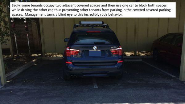 Some residents occupy two spaces and block both spaces while driving one car, thus preventing other residents from parking.