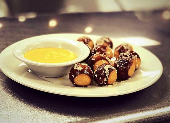 Pretzel Bites Served With Cheddar Cheese Sauce.