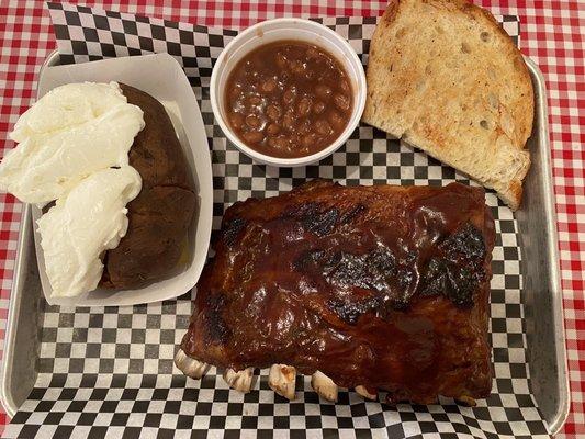 Rib Meal (6 rack) with a smoked baked potato w/ sour cream, baked beans & garlic bread. So delicious!