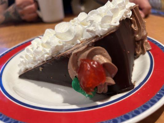 7 layer chocolate mousse cake with whipped cream on top !