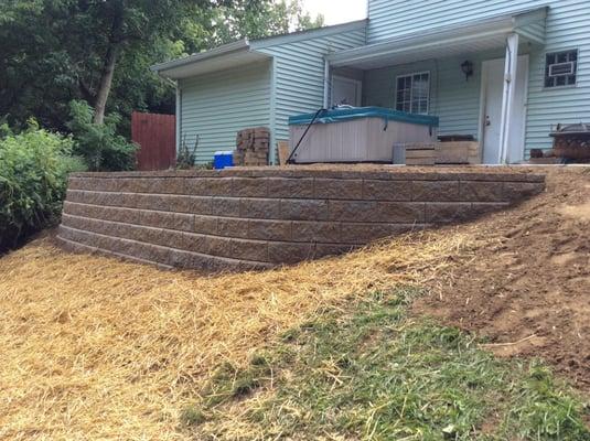 Took old wall that fell down and replaced it with proper retaining wall.