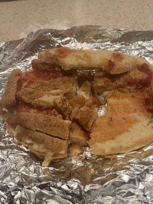 A disgusting dried out old chicken, cutlet Parmesan sandwich.