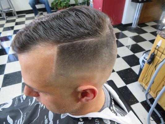 Mid skin fade with a hard part